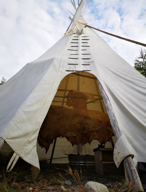 teepee with view of skin hanging inside